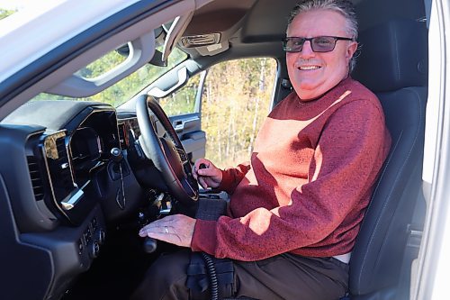 Westman’s Alberto Dallari in the driver's seat of his 2022 white Chevrolet Silverado Trail Boss crew cab. Dallari has muscular dystrophy and is unable to walk, but he drives his modified truck using customized hand controls and a ball-shaped knob on the steering wheel. (Michele McDougall/The Brandon Sun)