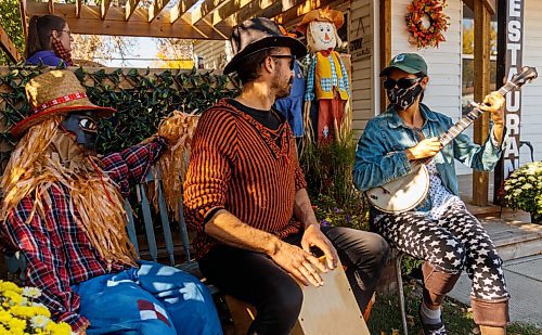 Blake Hamilton, left, and Abby Reuben play the drums and banjo in front of the Antlers and Oak Diner scarecrow display during last year's Souris Scarecrow Days. (Chelsea Kemp/The Brandon Sun)