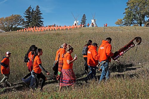 30092022
Participants walk through the site of the former Brandon Indian Residential School during the Orange Shirt Day Walk as part of Truth and Reconciliation Week 2022 on Friday. After hearing from speakers including residential school survivors participants walked from the RDC to the site of the former Brandon Indian Residential School and back. (Tim Smith/The Brandon Sun)