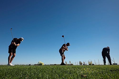 Kelvin Pople, Derek Smart and Alex Borges practise their swings at Mulligan's Driving Range & Practice Centre along Highway 1A just outside Brandon on a beautiful late-September Wednesday. Environment Canada is forecasting a high today of 31 C. (Tim Smith/The Brandon Sun)