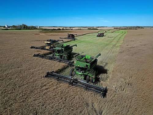 05092024
Four combines and a grain cart work to harvest 125 acres of canola near Oakden, Manitoba as part of the fourth annual Acres for Hamiota community harvest west of Hamiota on a sunny Tuesday. Acres for Hamiota raises money for community projects and organizations and this year all the machinery for the harvest was operated by women to highlight the important role women play in agriculture. The harvest was preceded by a picnic lunch.
Tim Smith/The Brandon Sun)