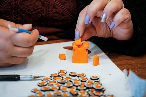 JOHN WOODS / FREE PRESS
Christine Brouzes, an artist who makes clay pins by hand to mark Orange Shirt Day, creates some her tiny creations in her home Monday, September 23, 2024. 

Reporter: malak