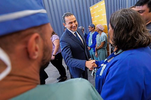 Premier Wab Kinew is greeted by health-care staff at the Grace Hospital in Winnipeg prior to announcing the Manitoba government is more than halfway to its goal of hiring 1,000 net new health-care workers. (Mike Deal/Winnipeg Free Press)