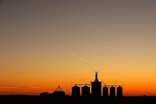 26092024
An airplane leaves a contrail across the orange sky over the Richardson Pioneer grain terminal in Kemnay shortly before sunrise on a warm Thursday morning. 
Tim Smith/The Brandon Sun) 