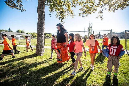 MIKAELA MACKENZIE / WINNIPEG FREE PRESS
	
Reanna Korade, grade three/four teacher at Victory School, and her students walk across the street to drop an envelope of letters to the founder of Orange Shirt Day, Phyllis Webstad, in a Canada Post box on Wednesday, Sept. 25, 2024. 

For Maggie story.
Winnipeg Free Press 2024