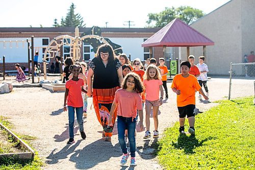 MIKAELA MACKENZIE / WINNIPEG FREE PRESS
	
Reanna Korade, grade three/four teacher at Victory School, and her students to drop an envelope of letters to the founder of Orange Shirt Day, Phyllis Webstad, in a Canada Post box on Wednesday, Sept. 25, 2024. 

For Maggie story.
Winnipeg Free Press 2024