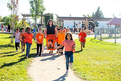 MIKAELA MACKENZIE / WINNIPEG FREE PRESS
	
Reanna Korade, grade three/four teacher at Victory School, and her students to drop an envelope of letters to the founder of Orange Shirt Day, Phyllis Webstad, in a Canada Post box on Wednesday, Sept. 25, 2024. 

For Maggie story.
Winnipeg Free Press 2024