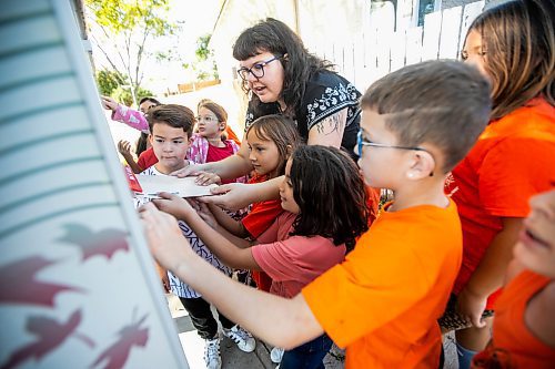 MIKAELA MACKENZIE / WINNIPEG FREE PRESS
	
Reanna Korade, grade three/four teacher at Victory School, and her students drop an envelope of letters to the founder of Orange Shirt Day, Phyllis Webstad, in a Canada Post box on Wednesday, Sept. 25, 2024. 

For Maggie story.
Winnipeg Free Press 2024