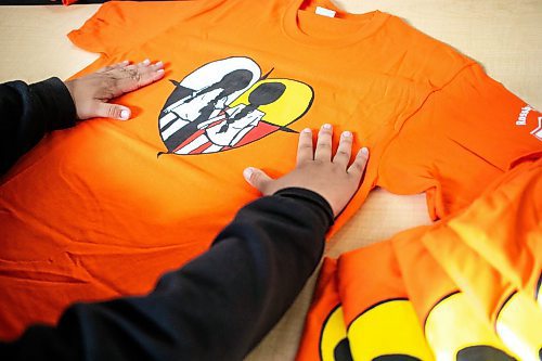 MIKAELA MACKENZIE / WINNIPEG FREE PRESS

Breanna Mink (16), who designed the orange shirt day t-shirts that Rossbrook House is selling to raise funds, at the inner-city drop-in centre on Thursday, Sept. 12, 2024. The unique design features the colours of the four directions and was created by a talented teenaged artist who has been a Rossbrook House participant for several years. Breanna is also one of the Junior Staff, a program that employs participants as young as 13 years of age.

Standup.
Winnipeg Free Press 2024