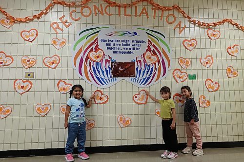 Betty Gibson School students imprinted their palms on pieces of paper cut in heart shapes and pasted them on a wall in the school hallway on Thiursday. (Abiola Odutola/The Brandon Sun)