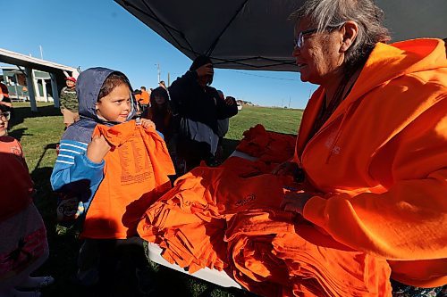 Norma McKay hands out shirts to students at the Rolling River First Nations powwow grounds on Friday for Truth and Reconciliation Day. (Connor McDowell/Brandon Sun)