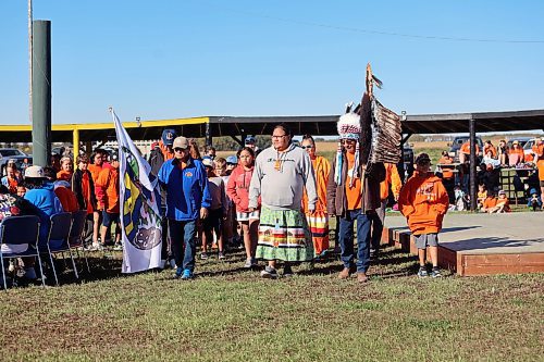 Chief Wilfred McKay Jr. (right) leads students and dignitaries on a march around the powwow grounds at Rolling River First Nation. The band held a day for Truth and Reconciliation on Friday. (Connor McDowell/Brandon Sun)