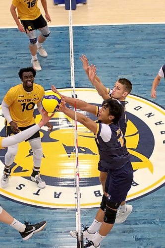 Bobcats import Sam Chen blocks a Warriors' attack during the first set. (Thomas Friesen/The Brandon Sun)