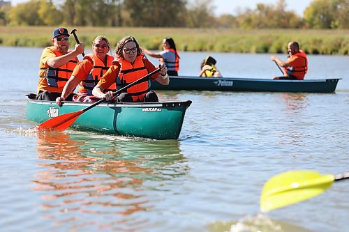 Brandon City Coun. Tyson Tame (Ward 10) paddles in the back of the canoe, with Brandon City Police Const. Amanda Conway in the middle. Their canoe was one of 16 that took part in the annual Pulling Together voyage on Saturday from Dinsdale Park to the Riverbank Discovery Centre on the Assiniboine River. The event was hosted by Brandon Police Service, Brandon Urban Aboriginal Peoples Council and Truth and Reconciliation Week Committee, to mark the National Day for Truth and Reconciliation. (Michele McDougall/The Brandon Sun)
