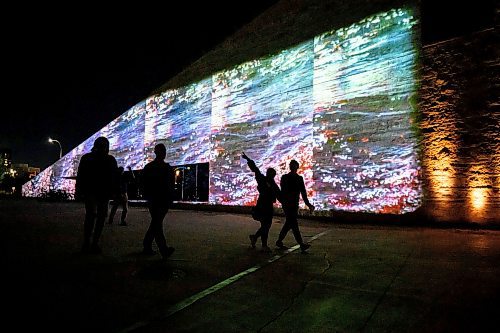 Mike Sudoma/Free Press
Festival goers take in the visuals and sounds of  Jamie Issacs exhibit Nibi as they enter the CMHR Saturday evening
Sept 28, 2024
