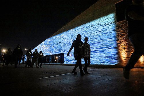 Mike Sudoma/Free Press
Festival goers take in the visuals and sounds of  Jamie Issacs exhibit Nibi as they enter the CMHR Saturday evening
Sept 28, 2024
