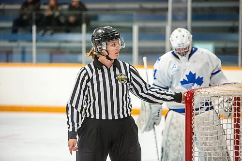 BROOK JONES / FREE PRESS
Hockey Manitoba linesperson Ally Wareham (No. 57) who is a female checks that the hcokey net is secure to its moorings during first period action between the St. James Jr. Canucks and the visiting Charleswood Hawks in a Manitoba Major Junior Hockey League game at the Ab McDonald Arena in Winnipeg, Man., Friday, Sept. 27, 2024.