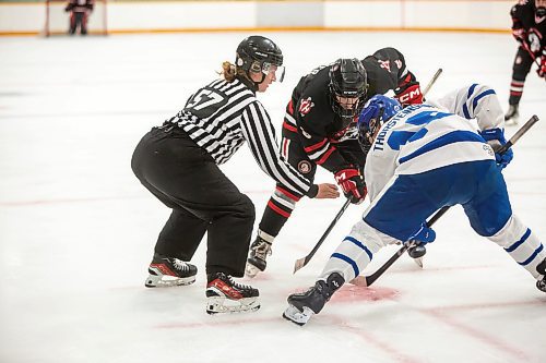 BROOK JONES / FREE PRESS
Hockey Manitoba linesperson Ally Wareham (No. 57) who is a female is about to drop the puck for a faceoff during first period action between the St. James Jr. Canucks and the visiting Charleswood Hawks in a Manitoba Major Junior Hockey League game at the Ab McDonald Arena in Winnipeg, Man., Friday, Sept. 27, 2024.