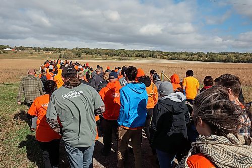 30092024
Participants make their way from Grand Valley Road across a field to the former Brandon Residential School site during the Truth and Reconciliation Week 2024 Orange Shirt Day Walk on Monday. The walk began and ended at the Riverbank Discovery Centre grounds with speeches, teaching and ceremony at the former Brandon Residential School site. (Tim Smith/The Brandon Sun)