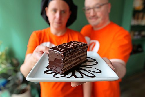 01102024
Angie and James Chambers of Chez Angela Bakery and Caf&#xe9; show their gluten-free 10-layer chocolate cake on Tuesday. The cake is Chez Angela&#x2019;s fair-trade creation for Fair Trade Treat Month. Lady of the Lake and The Dock on Princess also are participating in Fair Trade Treat Month.
(Tim Smith/The Brandon Sun)