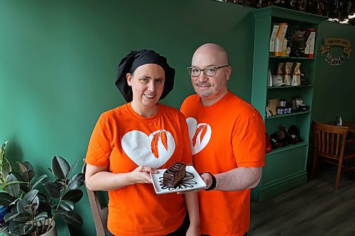 01102024
Angie and James Chambers of Chez Angela Bakery and Caf&#xe9; show their gluten-free 10-layer chocolate cake on Tuesday. The cake is Chez Angela&#x2019;s fair-trade creation for Fair Trade Treat Month. Lady of the Lake and The Dock on Princess also are participating in Fair Trade Treat Month.
(Tim Smith/The Brandon Sun)