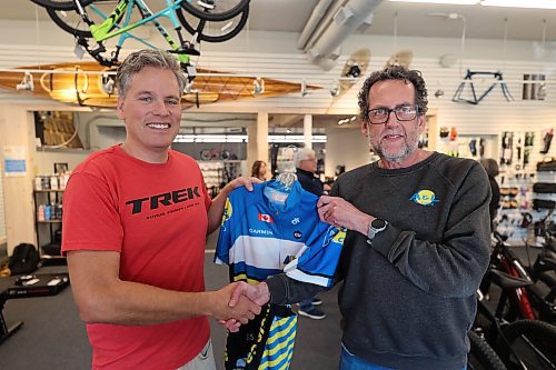 A&amp;L Cycle co-owner Cam Wirch shakes hand and present jersey to cyclist Grant Hamilton after the announcement on Wednesday afternoon at the A&amp;L Cycle office located at 201 Rosser Ave. (Abila Odutola/The Brandon Sun)