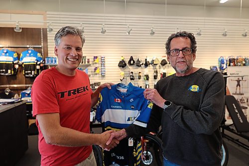 A&amp;L Cycle co-owner Cam Wirch shakes hand and present jersey to cyclist Grant Hamilton after the announcement on Wednesday afternoon at the A&amp;L Cycle office located at 201 Rosser Ave. (Abila Odutola/The Brandon Sun)