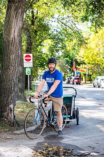 MIKAELA MACKENZIE / FREE PRESS
	
Andrew Kohan in the bike lane along Assiniboine Avenue (near where a moving vehicle recently blocked the route) on Wednesday, Oct. 2, 2024. While parking in bike lanes is illegal, it isn&#x574; often ticketed.

For Malak story.
Winnipeg Free Press 2024