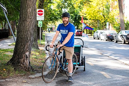 MIKAELA MACKENZIE / FREE PRESS
	
Andrew Kohan in the bike lane along Assiniboine Avenue (near where a moving vehicle recently blocked the route) on Wednesday, Oct. 2, 2024. While parking in bike lanes is illegal, it isn&#x574; often ticketed.

For Malak story.
Winnipeg Free Press 2024