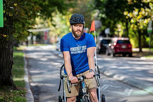 MIKAELA MACKENZIE / FREE PRESS
	
Andrew Kohan in the bike lane along Assiniboine Avenue (near where a moving vehicle recently blocked the route) on Wednesday, Oct. 2, 2024. While parking in bike lanes is illegal, it isn&#x574; often ticketed.

For Malak story.
Winnipeg Free Press 2024