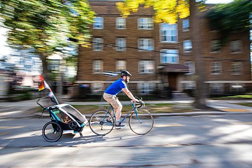 MIKAELA MACKENZIE / FREE PRESS
	
Andrew Kohan cycles in the bike lane along Assiniboine Avenue (near where a moving vehicle recently blocked the route) on Wednesday, Oct. 2, 2024. While parking in bike lanes is illegal, it isn&#x574; often ticketed.

For Malak story.
Winnipeg Free Press 2024