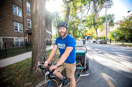 MIKAELA MACKENZIE / FREE PRESS
	
Andrew Kohan in the bike lane along Assiniboine Avenue (near where a moving vehicle recently blocked the route) on Wednesday, Oct. 2, 2024. While parking in bike lanes is illegal, it isn&#x574; often ticketed.

For Malak story.
Winnipeg Free Press 2024