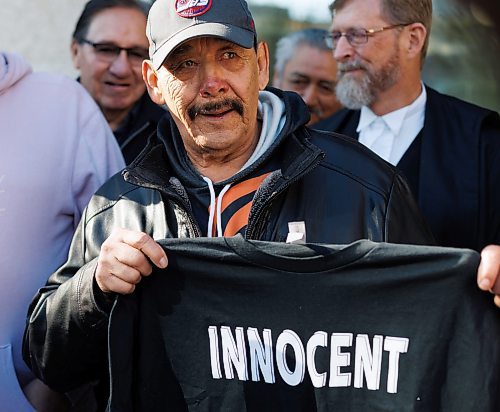 MIKE DEAL / FREE PRESS

Clarence Woodhouse holds up a T-shirt outside court Thursday after being acquitted and declared innocent of a 1973 slaying.