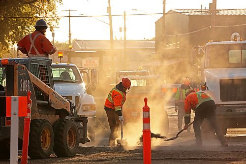 Workers continue with repaving work on 18th Street at Park Avenue as the sun comes up on Thursday morning. Depending on weather conditions, some work may be carried over into next year, a provincial spokesperson told the Sun. (Tim Smith/The Brandon Sun)