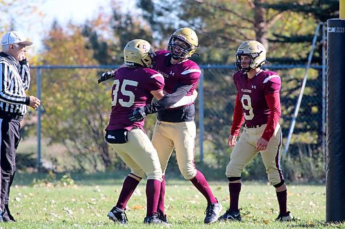 Crocus Plainsmen Isaac Bromley, centre, celebrates an interception return for a touchdown with Riley Bean (35) and Adam Pierreroy during their Winnipeg High School Football League game against the Sturgeon Heights Huskies at Crocus on Thursday. (Thomas Friesen/The Brandon Sun)