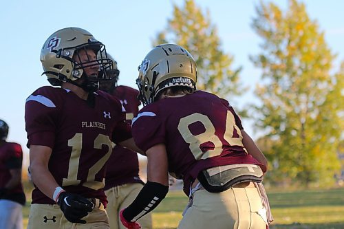 Crocus Plainsmen Hayden Foster (12) and Cole Klassen celebrate Klassen's game-winning touchdown during their Winnipeg High School Football League game against the Sturgeon Heights Huskies at Crocus on Thursday. (Thomas Friesen/The Brandon Sun)