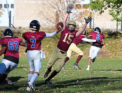 Crocus Plainsmen Jack Simpson (15) jumps to deflect a pass by Sturgeon Heights Huskies quarterback Ben Waters during their Winnipeg High School Football League game at Crocus on Thursday. (Thomas Friesen/The Brandon Sun)