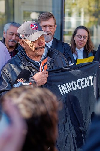 MIKE DEAL / FREE PRESS
Clarence Woodhouse holds up a t-shirt that says &#x201c;Innocent&#x201d; on it to the media as he leaves court with family and his lawyers after being acquitted and declared innocent of the killing that took place in Winnipeg in 1973.
Reporter: Katrina Clarke
241003 - Thursday, October 03, 2024.