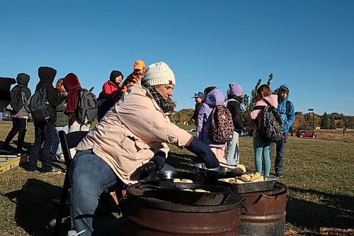 03102024
Amanda Dupuis, Community Housing and Wellness Programmer with the City of Brandon, cooks bannock for students taking part in Truth and Reconciliation Week 2024 programming at the Riverbank Discovery Centre grounds on Thursday. Today is the final day of Truth and Reconciliation Week with events including the Sisters in Spirit Petal Ceremony at Dinsdale Park, Healing by the River at the Discovery Centre as well as closing ceremonies and a feast.
(Tim Smith/The Brandon Sun)