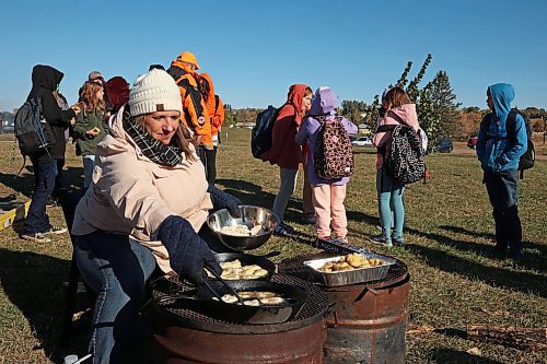 03102024
Amanda Dupuis, Community Housing and Wellness Programmer with the City of Brandon, cooks bannock for students taking part in Truth and Reconciliation Week 2024 programming at the Riverbank Discovery Centre grounds on Thursday. Today is the final day of Truth and Reconciliation Week with events including the Sisters in Spirit Petal Ceremony at Dinsdale Park, Healing by the River at the Discovery Centre as well as closing ceremonies and a feast.
(Tim Smith/The Brandon Sun)