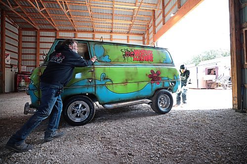 Ruth Bonneville / Free Press

BIZ -  Six Pines Haunted Attractions

Photo of Thomas and his dad James pushing their newly painted Scooby Doo Van, The Mystery Machine, into a photo booth space with haunted Scooby Doo characters Thursday. 

Story on Six Pines Haunted Attractions the Thevenot family, James and Judy Thevenot, the owner-operators, and their son, Thomas Thevenot,  who plans to take over the family business one day.

Subject: Six Pines Haunted Attractions is a 26-year-old haunted house attraction near Stonewall. The attraction receives hundreds of visitors every October who walk through three different haunted houses on the property, which change themes annually.

Story by. Aaron

Oct 3rd , 2023
