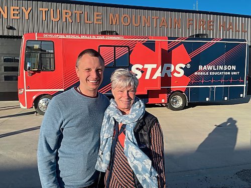 Dr. Mark Bemment stands with his wife, Rachelle, in front of the STARS mobile education unit outside the Killarney-Turtle Mountain Fire Hall Thursday evening. (Michele McDougall/The Brandon Sun)