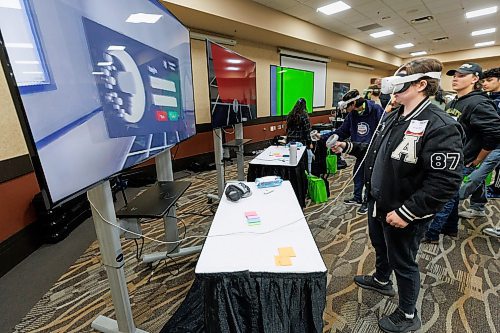 MIKE DEAL / FREE PRESS
Shelby Brown, 16, grade 11 student at Crocus Plains Regional Secondary School in Brandon, MB, tries out a virtual training tool running a program, Sprayverse, that helps teach the process of industrial painting, during a demonstration at the Automotive Trades Association (ATA) second annual High School Career Day being held at CanadInns Polo Park on Friday.
Reporter: Aaron Epp
241004 - Friday, October 04, 2024.