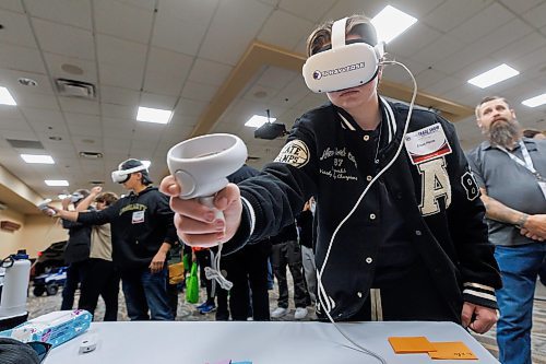 MIKE DEAL / FREE PRESS
Shelby Brown, 16, grade 11 student at Crocus Plains Regional Secondary School in Brandon, MB, tries out a virtual training tool running a program, Sprayverse, that helps teach the process of industrial painting, during a demonstration at the Automotive Trades Association (ATA) second annual High School Career Day being held at CanadInns Polo Park on Friday.
Reporter: Aaron Epp
241004 - Friday, October 04, 2024.