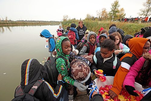 04102024
Students from &#xc9;cole New Era School take flower petals to place in the Assiniboine River in honour and remembrance of missing and murdered indigenous women and girls during the Sisters In Spirit petal ceremony at Dinsdale Park on Friday morning.  
(Tim Smith/The Brandon Sun)