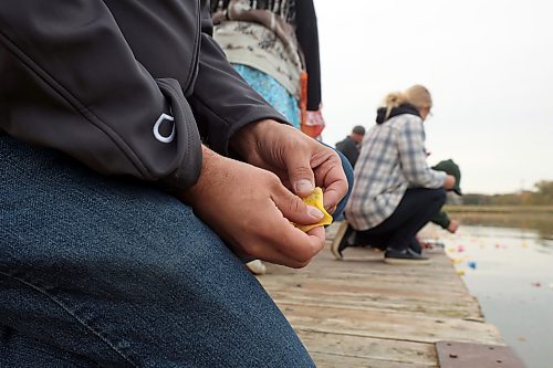 04102024
Participants place flower petals and tobacco in the Assiniboine River in honour and remembrance of missing and murdered indigenous women and girls during the Sisters In Spirit petal ceremony at Dinsdale Park on Friday morning.  
(Tim Smith/The Brandon Sun)