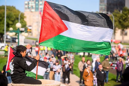 Mike Sudoma/Free Press
Young supporter Najmeddin Elbakri flies a Palestinian flag during a pro Palestinian rally at the Manitoba Legislative Grounds Saturday afternoon 
October 5, 2024
