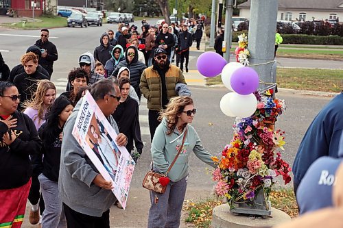 A memorial walk crosses Victoria Avenue on Saturday at the crosswalk where Antoine Sutherland was killed last year. (Connor McDowell/Brandon Sun)