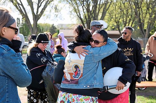 Nicole Sutherland stands at the front of a lineup of people waiting to give her a hug at Vincent Massey High School on Saturday. (Connor McDowell/Brandon Sun)