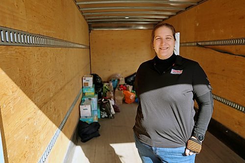 Stephanie Sansom stands inside the freightliner on Saturday in front of some early donations. Donations behind her include granola bars, diapers, pasta, juice and noodles. Donations go to the Community Health and Housing Association and the Samaritan House Ministries food bank. Fill the Freightliner is organized by Premier Truck Group. (Connor McDowell/Brandon Sun)